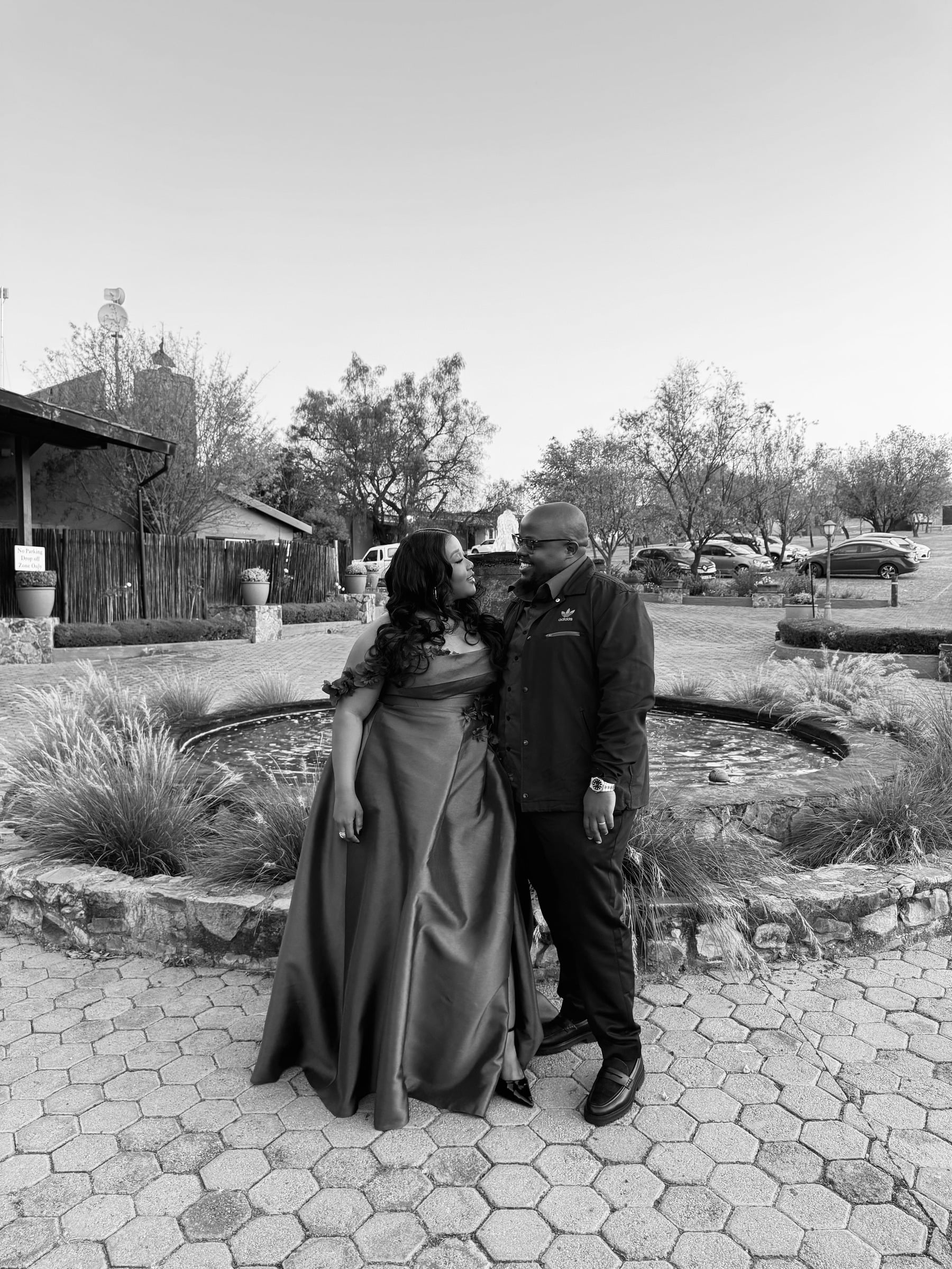 Black-and-white portrait of the couple in their formal outfits