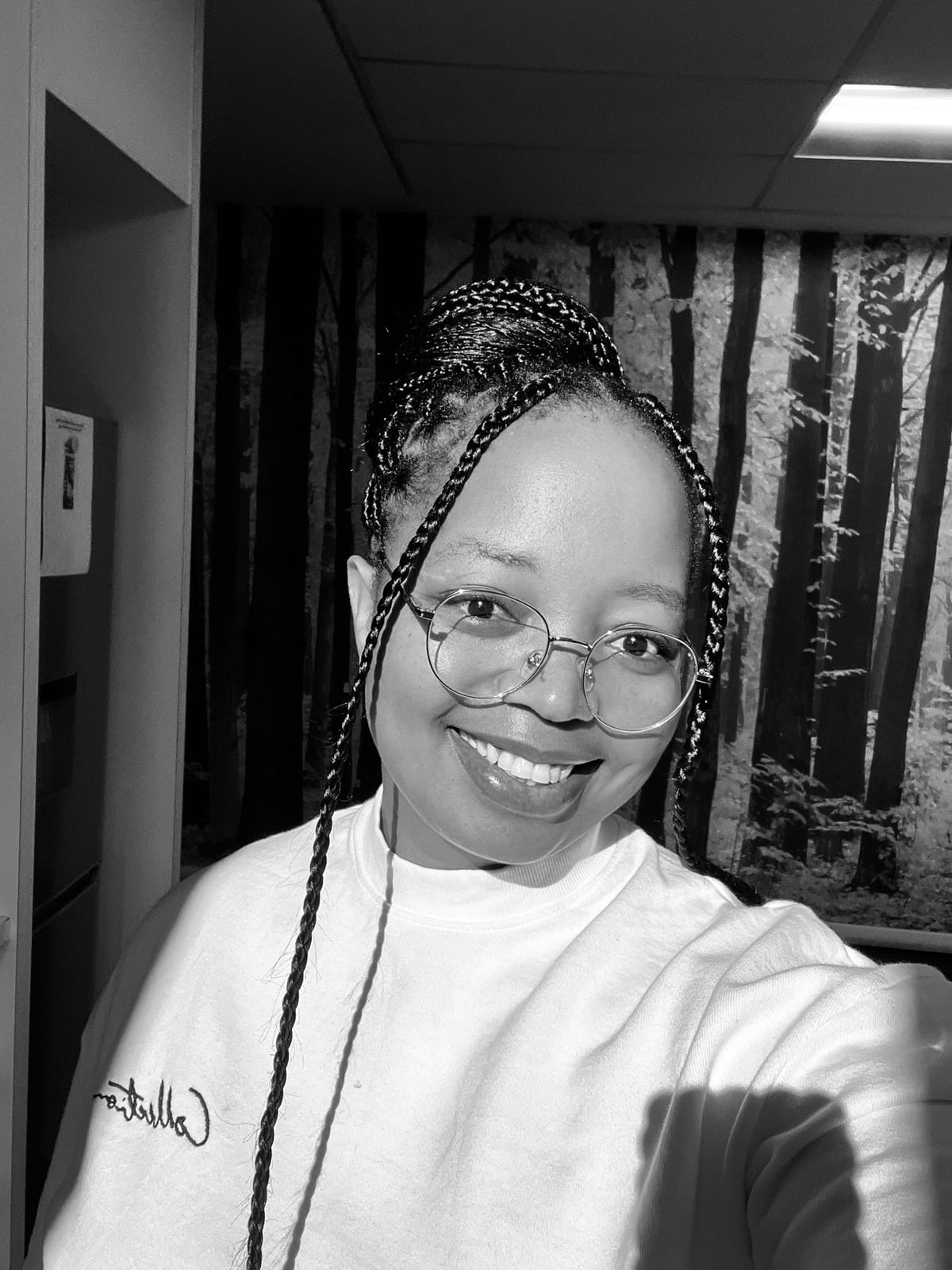 The Maid of Honour — black-and-white selfie of a smiling woman with braids and glasses